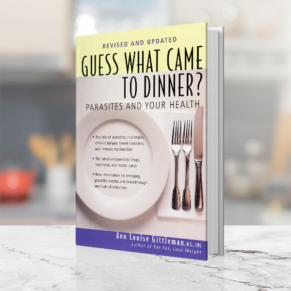 The front cover of Ann Louise Gittleman's Guess Who Came to Dinner? Book which has a plate, two forks, and a knife.