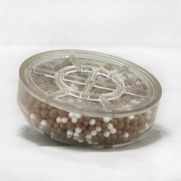 A replacement water filter for bathtubs that is filled with brown and white beads.