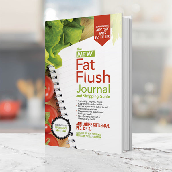 Ann Louise Gittleman's The New Fat Flush Journal and Shopping Guide on a white and gray kitchen countertop.